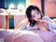 A woman laying on top of a bed in a bedroom.